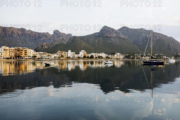 Village by the sea and mountains at sunrise, Port de Pollenca, Serra de Tramuntana, Majorca,