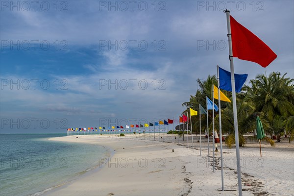 White sand beach with many flags, Bangaram island, Lakshadweep archipelago, Union territory of