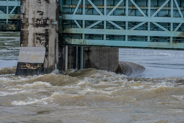 Closeup of dam with water surging through open floodgates after torrential monsoon rains in Daejeon