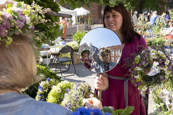 Riga. Ligo festival. Binding of midsummer wreaths. Flower wreaths, stalls in the city square, Riga,