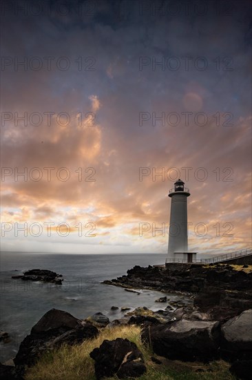 White lighthouse on a steep coast. Dramatic clouds with a view of the sea, pure Caribbean at Le