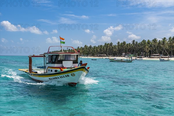 Little boats before a palm fringed white sand beach, Agatti Island, Lakshadweep archipelago, Union
