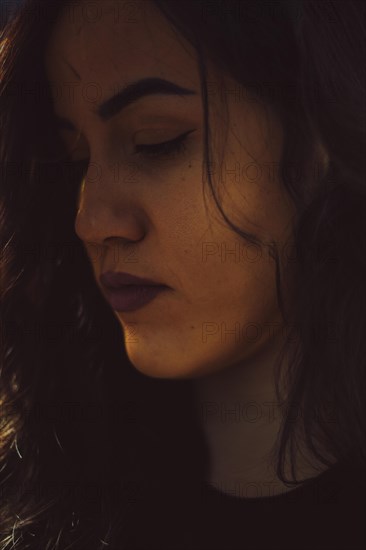 Close-up of a woman's face in a moody, introspective ambiance, a complete tool panel in background