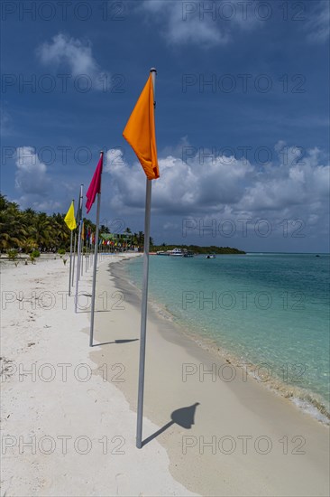 White sand beach with many flags, Bangaram island, Lakshadweep archipelago, Union territory of