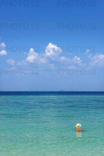 Man with hat bathing in the sun in the sea, ocean, Andaman Sea, ozone, heat, sunstroke, sunscreen,