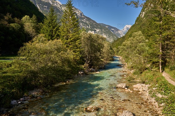 River Soca in the Trenta Valley, on the right a hiking trail through the Soca Valley, Trenta