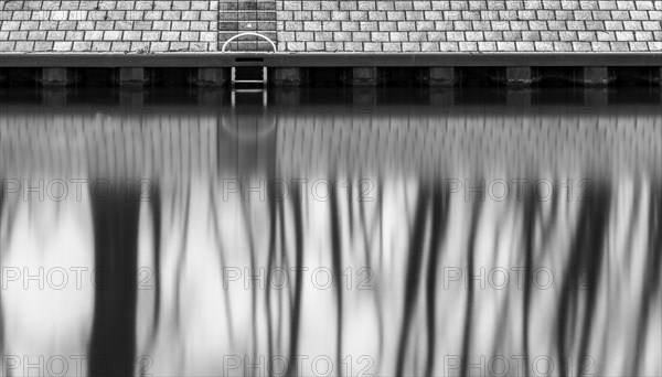 Long exposure, reflection of trees in the water of the Spree, Am Schleusenkanal, Berlin, Germany,