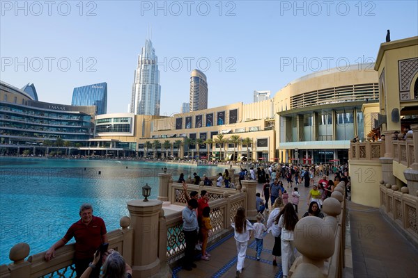 Tourists in front of the skyscraper backdrop at Lake Burj Khalifa. Dubai, United Arab Emirates,