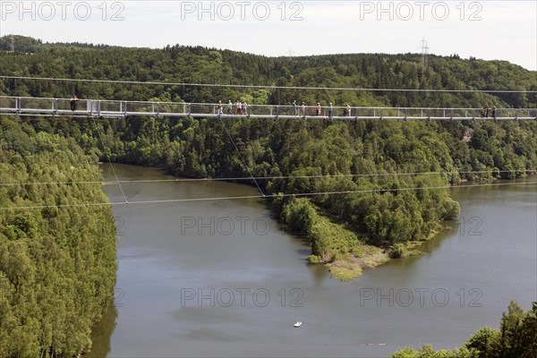 Visitors cross the rope suspension bridge at the Rappbode dam, 483 metres long, 100 metres above