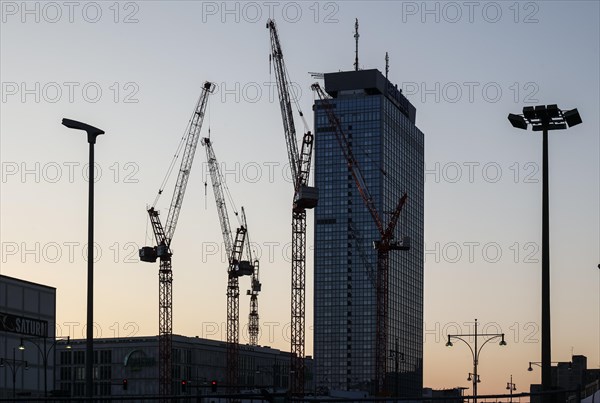 Cranes at the construction site of the Covivio high-rise, next to the Park Inn by Radisson Berlin