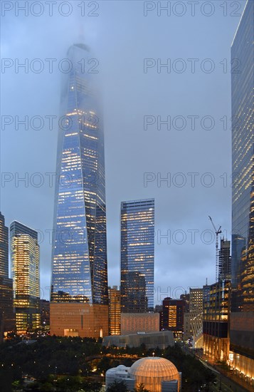 Skyscraper One World Trade Centre or Freedom Tower at the top shrouded in fog, at dusk, Ground