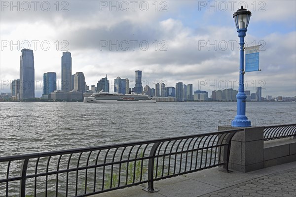 Street lamp marking the potential future flood level caused by global warming, in the background