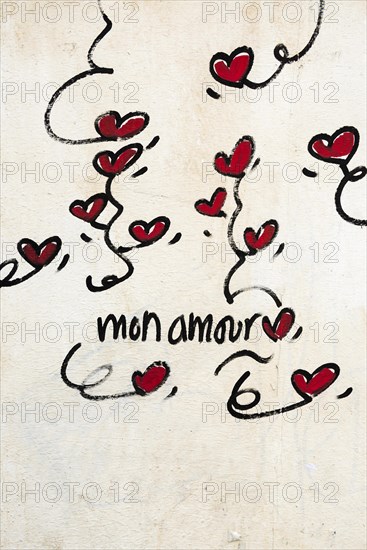 Street art, painted house wall with hearts and lettering on the theme of love, Montmartre, Paris,