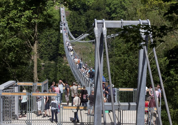Visitors cross the rope suspension bridge at the Rappbode dam, 483 metres long, 100 metres above
