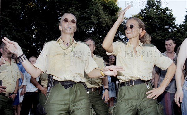 Policewomen of the Berlin police celebrate with techno fans during the Love Parade. Techno music