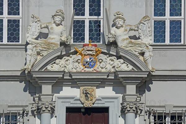 Portal with town coat of arms, figures and decorations from the baroque town hall, detail, sword,
