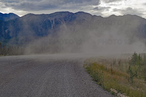 Long plume of dust on a gravelled section of the Alaska Highway, Yukon Territory, Canada, North