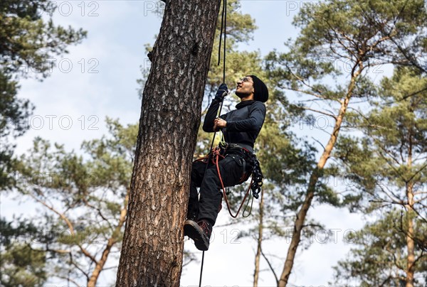 An activist pulls himself up a rope to one of the tree houses in the Gruenheide forest. The