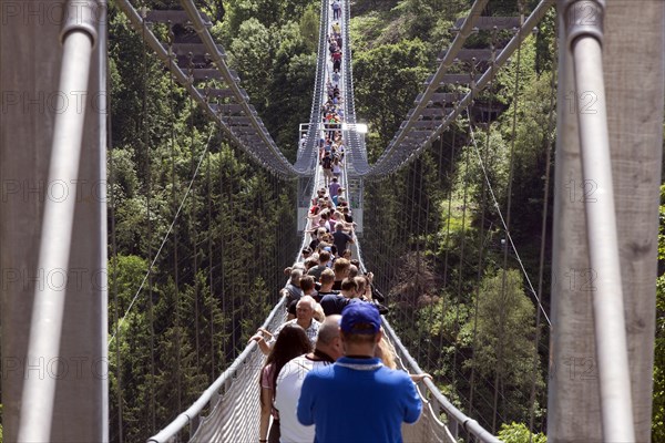Visitors cross the rope suspension bridge at the Rappbode dam, 483 metres long, 100 metres above