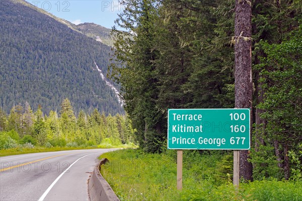 Road sign with distances on the Yellowhead Highway, no traffic, wilderness, Terrace, Kitimat,