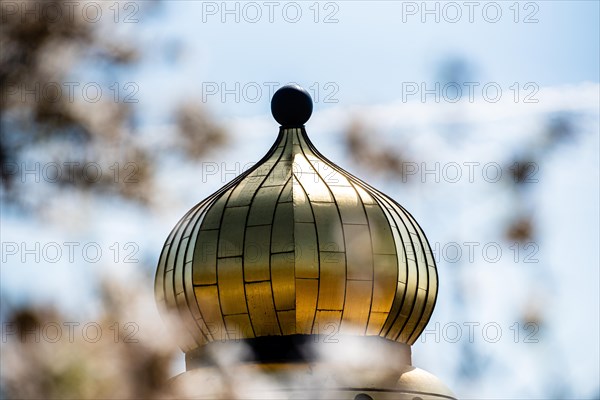 Close-up of a shiny golden dome with the sky in the background, Hundertwasser Kindergarten,