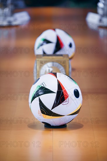 Two footballs lie on the cabinet table during a cabinet meeting at the Federal Chancellery in