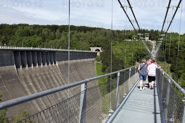 Visitors cross the rope suspension bridge at the Rappbode dam, 483 metres long, 100 metres above