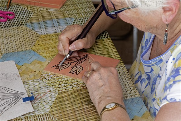 Oaxaca, Mexico, Susan Newell works on her image of tulips at an engraving workshop led by Alejandra