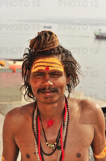 Portrait of a sadhu with face painting and religious symbols in Varanasi, Varanasi, Uttar Pradesh,
