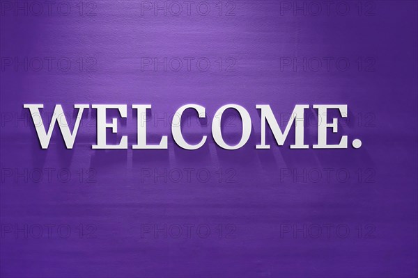 A simple purple wall with 'WELCOME.' in white lettering as a greeting, BMW WELT, Munich, Germany,