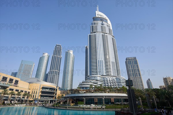 Tourists in front of the skyscraper backdrop at Lake Burj Khalifa. Dubai, United Arab Emirates,