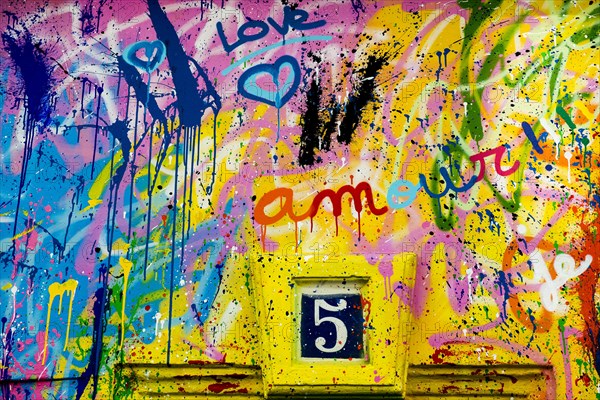 Street art, painted house wall with hearts and lettering on the theme of love, Montmartre, Paris,