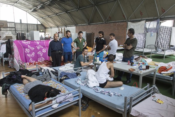Refugees from Syria are housed in a gymnasium at the central contact point for asylum seekers in
