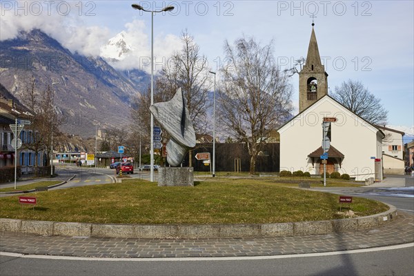 Bell tower with church Clocher de la chapelle St. Michel, art in the roundabout by Antoine Poncet