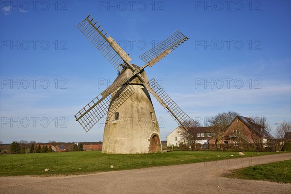 Windmill Auf der Hoechte under a cloudless blue sky is part of the Westphalian Mill Road in Hille,