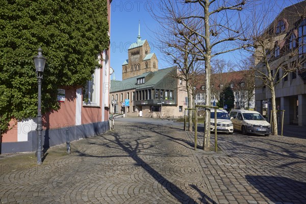 City centre with cobblestones, lantern, taxis at the taxi rank and commercial buildings and the
