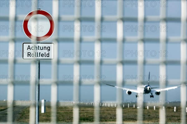 A Lufthansa aircraft lands at Frankfurt Airport, warning sign with the inscription Achtung