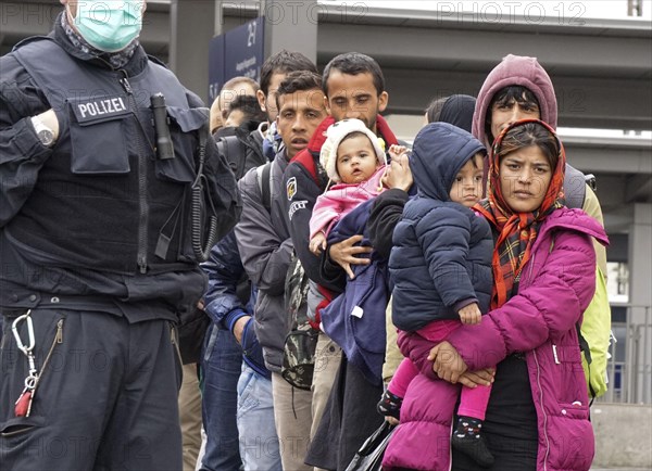 Refugees arriving at Rosenheim station, being taken to registration by federal police officers,
