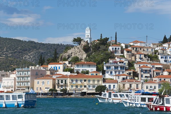View of an idyllic Mediterranean coastal town with harbour, whitewashed houses and blue sky, view