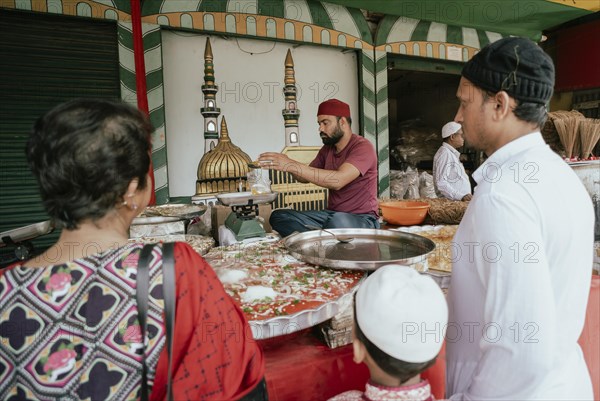 People buy food at a stall to break their fast during the holy month of Ramadan, on March 15, 2024