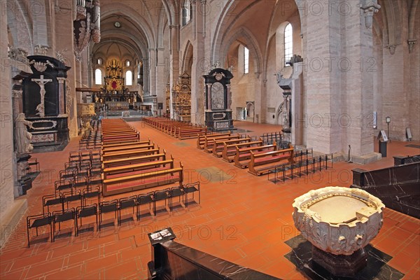 Interior view with baptismal font from UNESCO St Peter's Cathedral, empty pews, altar, Trier,