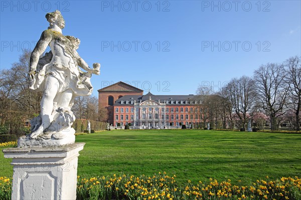 Electoral palace and Constantine basilica with palace garden and white sculpture in spring and