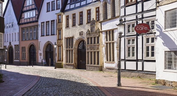 Historic facades, lantern and sign for the cafe with backlight in the Schnurrviertel in the old