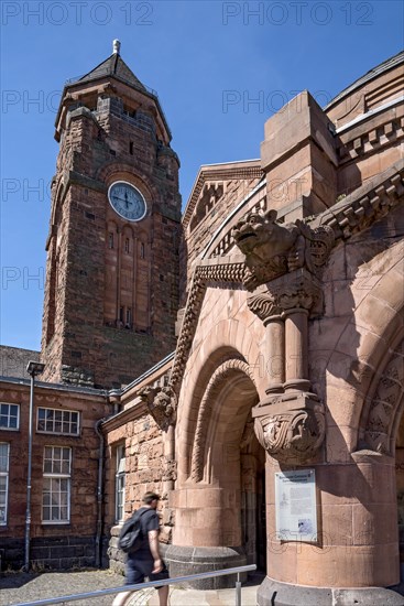 Historic Wilhelmine railway station, clock tower, pavilion with gargoyle, entrance to the station