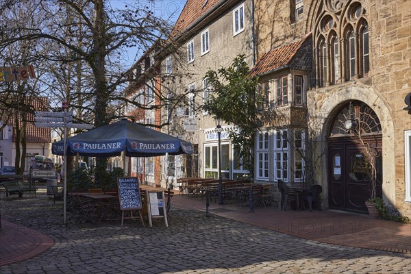 Restaurant with outdoor area, umbrella and benches in the Schnurrviertel in Minden, Muehlenkreis