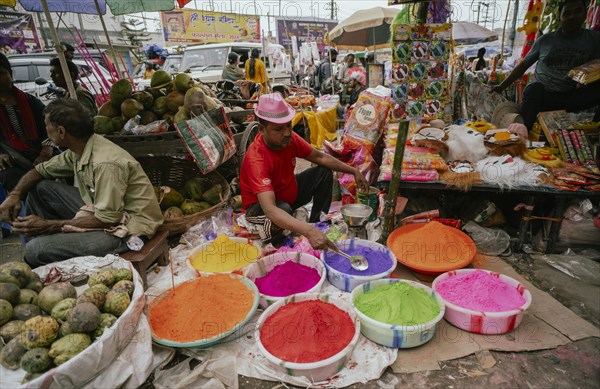 Vendor sells Holi celebration items in a street market, ahead of Holi festival on March 23, 2024 in