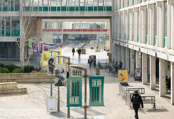 Students walking in campus square area, University of Essex, Colchester, Essex, England, UK
