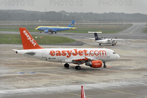EasyJet aircraft on the tarmac next to airport vehicles, Hamburg, Hanseatic City of Hamburg,