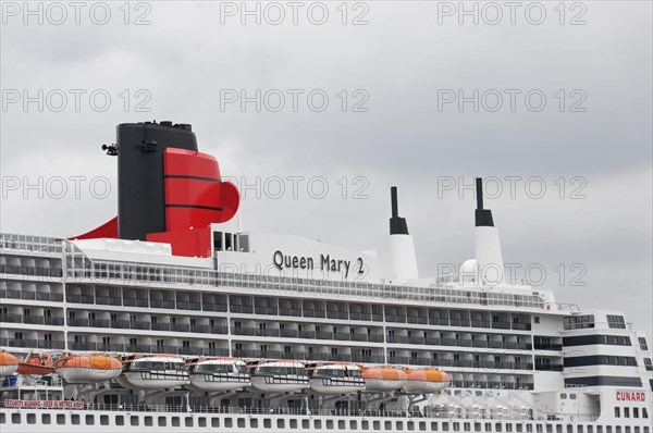 Close-up of a cruise ship smokestack Queen Mary 2, with orange lifeboats, Hamburg, Hanseatic City