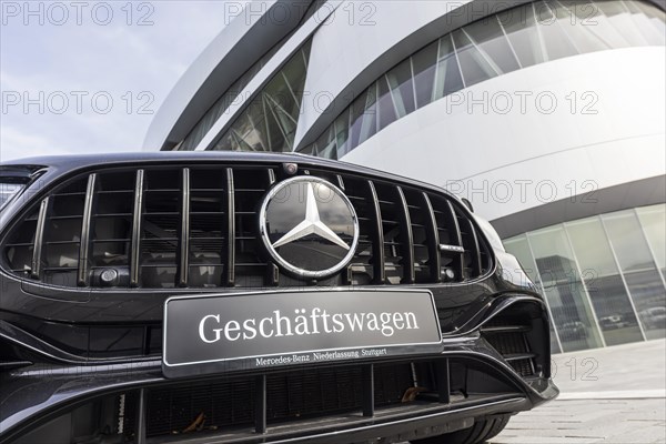 Mercedes company car, radiator grille and Mercedes star on a modern vehicle, in the background the